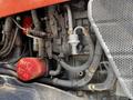 Close-up of the engine assembly of a 2011 Kubota M8540D with visible hoses filters and components