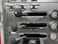 A metallic panel from a 1991 Sutphen Deluge featuring multiple levers and gauges labeled for firehose use and water pressure measurement