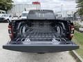 A 2024 RAM 2500 truck with an open bed showing the cargo area and tailgate