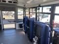 Interior view of a 2020 Chevrolet Express showing upholstered passenger seats arranged in a row facing forward