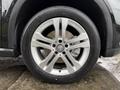 Close-up of a silver alloy wheel with a Mercedes-Benz logo on a 2016 Mercedes-Benz GLA-250 tire