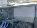 Interior view of a 2015 Ford F-450 SD dashboard featuring stereo controls and a storage compartment labeled SUPER DUTY
