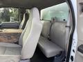 Interior of a 2008 Ford F-450 featuring two front seats and a rear bench seat with a large wooden surface on the center console