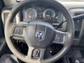 Steering wheel of a 2012 RAM 2500 with a prominent RAM logo and control buttons visible