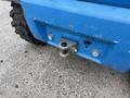 Close-up of a blue 2020 Genie GTH-5519 utility vehicle showing the rear hitch mounted underneath with a bolt and a pin visible