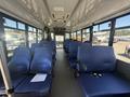 Interior of a 2020 Chevrolet Express with blue fabric seats arranged in rows and ample space in the middle aisle
