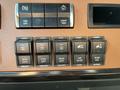 Dashboard controls of a 2022 Freightliner Cascadia featuring various buttons for axle locks suspension adjustments and light tests
