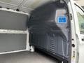 Interior view of a 2023 Mercedes-Benz Metris cargo van showing a gray wall panel with a blue sticker for cargo securing