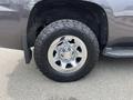 Close-up of a chrome wheel with a tire on a 2016 Chevrolet Tahoe showing a distinctive Chevrolet logo on the hubcap