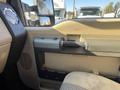 Interior view of a 2014 Ford F-350 SD showing the driver's side door panel with a handle and control buttons