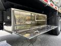 A stainless steel storage compartment with a hinged door on a 2010 Freightliner M2 106 truck
