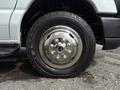 A close-up of the wheel of a 2017 Ford Econoline featuring a shiny metallic rim and a rugged tire with visible tread patterns