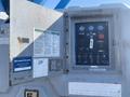Control panel of a 1997 Genie S-65 4X4 featuring switches and gauges for operating the equipment