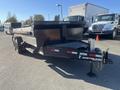 A 2024 Southland 18 foot dump trailer featuring a black finish dual axles and a ramp for loading and unloading materials