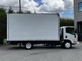 A 2018 Isuzu NPR truck with a large white box cargo area and white wheels parked on a concrete surface