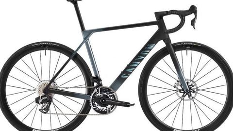 A 2026 Canyon Ultimate CFR AXS road bike featuring a sleek design with a black and gray frame disc brakes and high-performance wheels