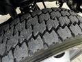 Close-up of a treaded tire from a 2007 Ford F-550 showcasing deep grooves and textured surface designed for traction on various terrains
