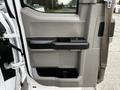 Interior door panel of a 2016 Ford F-150 featuring a black and gray design with a door handle and storage compartment