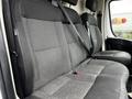 Interior view of the rear bench seat of a 2018 RAM Promaster with black fabric upholstery and seat belts installed
