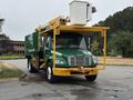 A green 2015 Freightliner M2 106 truck equipped with a yellow aerial lift and a white bucket mounted on top