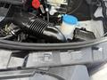 A 2016 Mercedes-Benz Sprinter engine compartment showing the air intake system and various components including a blue cap and a label from Daimler AG