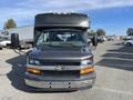 A 2017 Chevrolet Express van facing forward with black and gray exterior and a large front cabin area