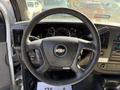 Steering wheel of a 2017 Chevrolet Express with a central logo and dashboard instruments visible behind it
