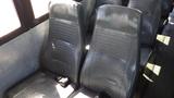 Interior seats of a 2014 Freightliner Thomas diesel bus featuring gray vinyl upholstery and seatbelts