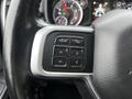 Close-up of a steering wheel with control buttons for voice commands and phone functions on a 2020 RAM 3500