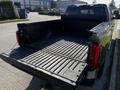 A 2023 Toyota Tundra with an empty truck bed showcasing its black liner and spacious cargo area