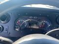 Dashboard of a 2012 Ford Econoline showing speedometer, fuel gauge, and various indicators with a black interior design