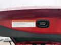A 2016 Mitsubishi Outlander electric tailgate button and warning label
