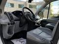Interior view of a 2015 Ford Transit showing the driver's seat dashboard and steering wheel