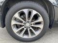 Close-up of a silver alloy wheel with eight spokes on a 2015 Kia Sorento tire showing a BFGoodrich tire brand