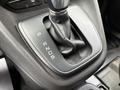 Gear shift lever of a 2016 Ford Transit Connect featuring P R N D S letters on a black console