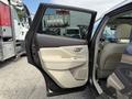 A 2016 Nissan Murano with an open passenger door featuring a beige interior and modern handle design