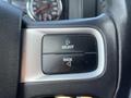 Close-up of buttons on the steering wheel of a 2011 RAM 1500 labeled Select and Back