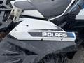 Close-up of a 2017 Polaris Scrambler with a white and black design featuring the Polaris logo on the side panel