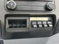The dashboard panel of a 2016 Ford F-550 featuring buttons for bin lights flashers and four auxiliary switches