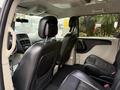 A 2017 Dodge Grand Caravan interior showing black leather seats with a focus on the second row and front dashboard features