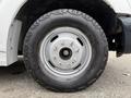 Close-up of a tire and wheel of a 2015 Ford F-350 SD featuring a rugged tread pattern and silver rim