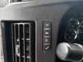 Control panel of a 2020 Chevrolet Express showing buttons for lights, stability control, and an indicator light next to a ventilation grille