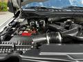 Engine compartment of a 2020 Ford F-350 Super Duty showing various components including the air intake system and battery connections