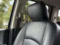 Black leather seat of a 2018 RAM 1500 featuring the RAM logo embossed on the headrest