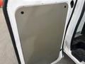 A 2009 Ford Econoline van door with a smooth metallic panel installed over the inner surface