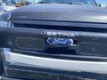 A 2013 Ford Expedition with a black front grill and a SETINA push bar featuring the Ford logo in the center