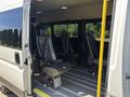 A 2016 RAM Promaster with an open side door showing four fabric-covered seats arranged inside the vehicle