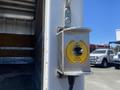 A metallic control box mounted on a wall featuring a switch labeled "UP LEVER" and "DOWN BAISER" indicating directions for operation