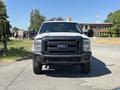 A white 2014 Ford F-250 Super Duty with a black grille and large tires facing forward