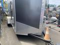 A 2020 Stealth Enterprises Trailer with a diamond plate exterior and a cone positioned near the hitch